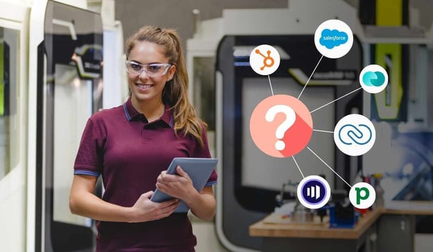 Shop owner stands in front of CNC 5-axis mills